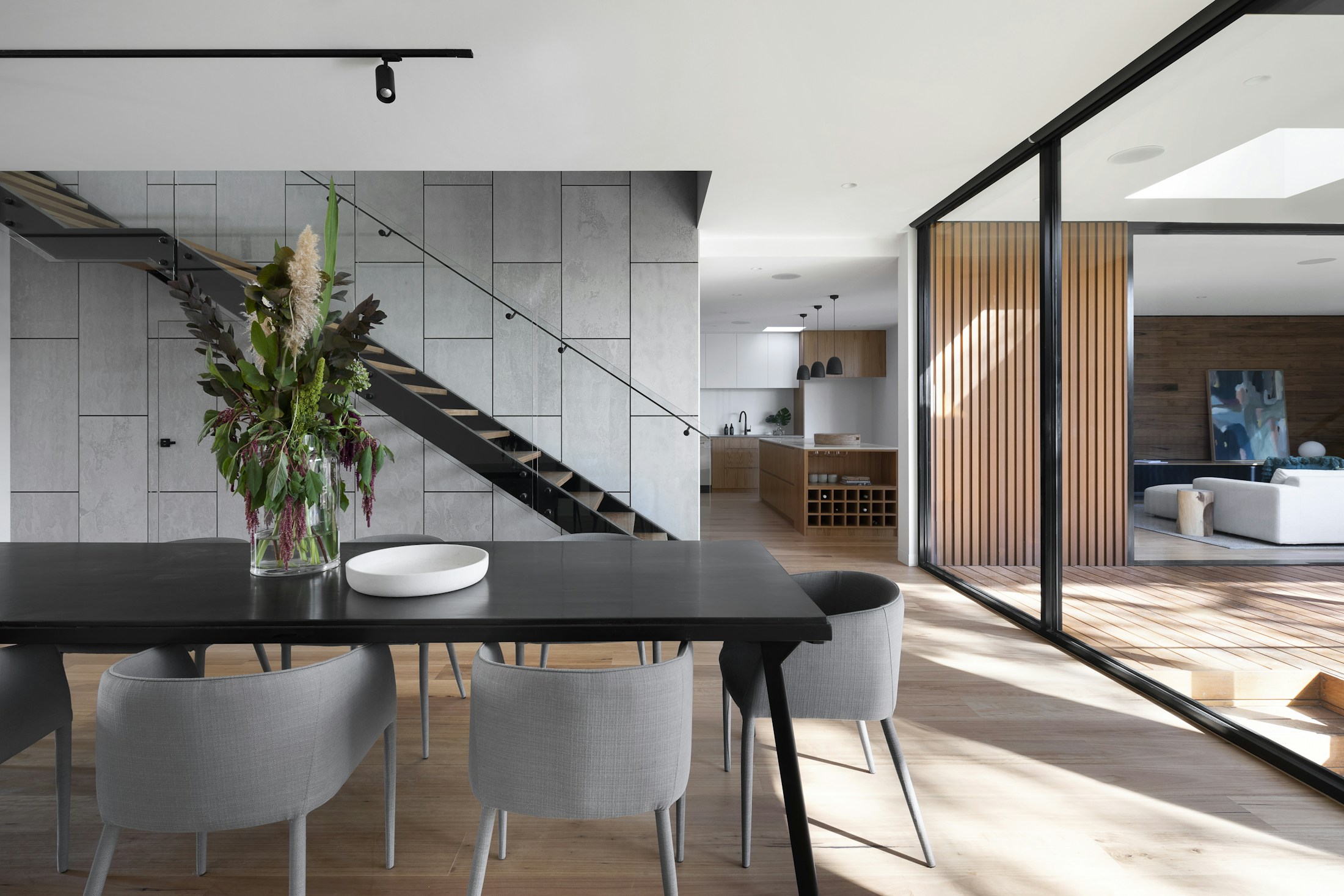 Sculptural furniture and natural materials in a light-filled architectural interior